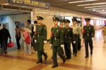 Chinese People's Armed Police Force Patrolling Train Station, Shanghai, China